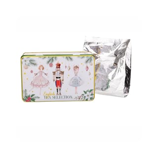 New English Teas Nutcracker Dose neben einem silbernen Folienbeutel mit Tee