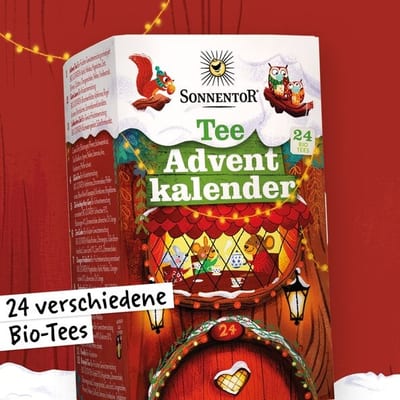 Sonnentor advent calendar box illustrated with animals at a tea table, labeled Tee Adventkalender and 24 organic teas, with a door marked 24.