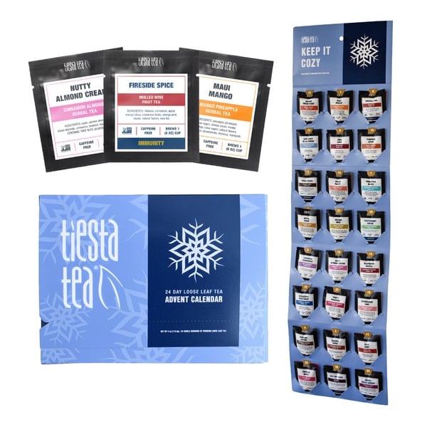 Blue Tiesta Tea box labeled 24 Day Loose Leaf Tea Advent Calendar, with snowflakes and pouches including Nutty Almond Cream, Fireside Spice and Maui Mango, some marked caffeine free, beside a Keep It Cozy board of pouches.